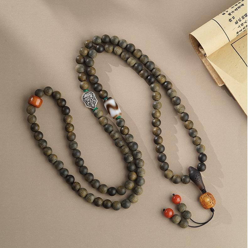 Spiritual Tibetan 108 prayer beads combining agarwood, bone, silver, and agate for mindfulness practice.