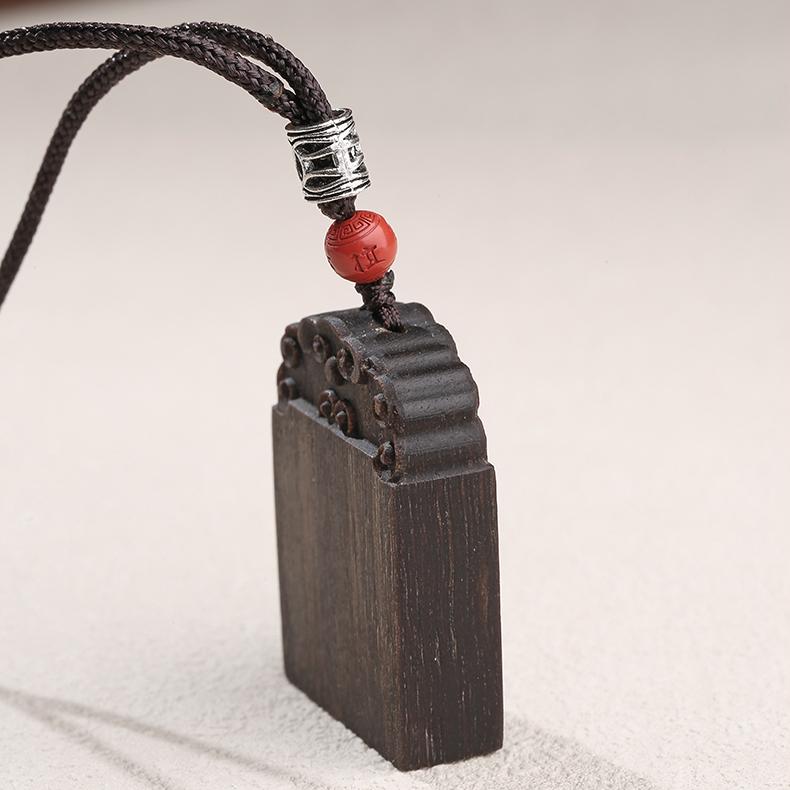 Tibetan Buddhist agarwood amulet pendant crafted for peace and mindfulness.