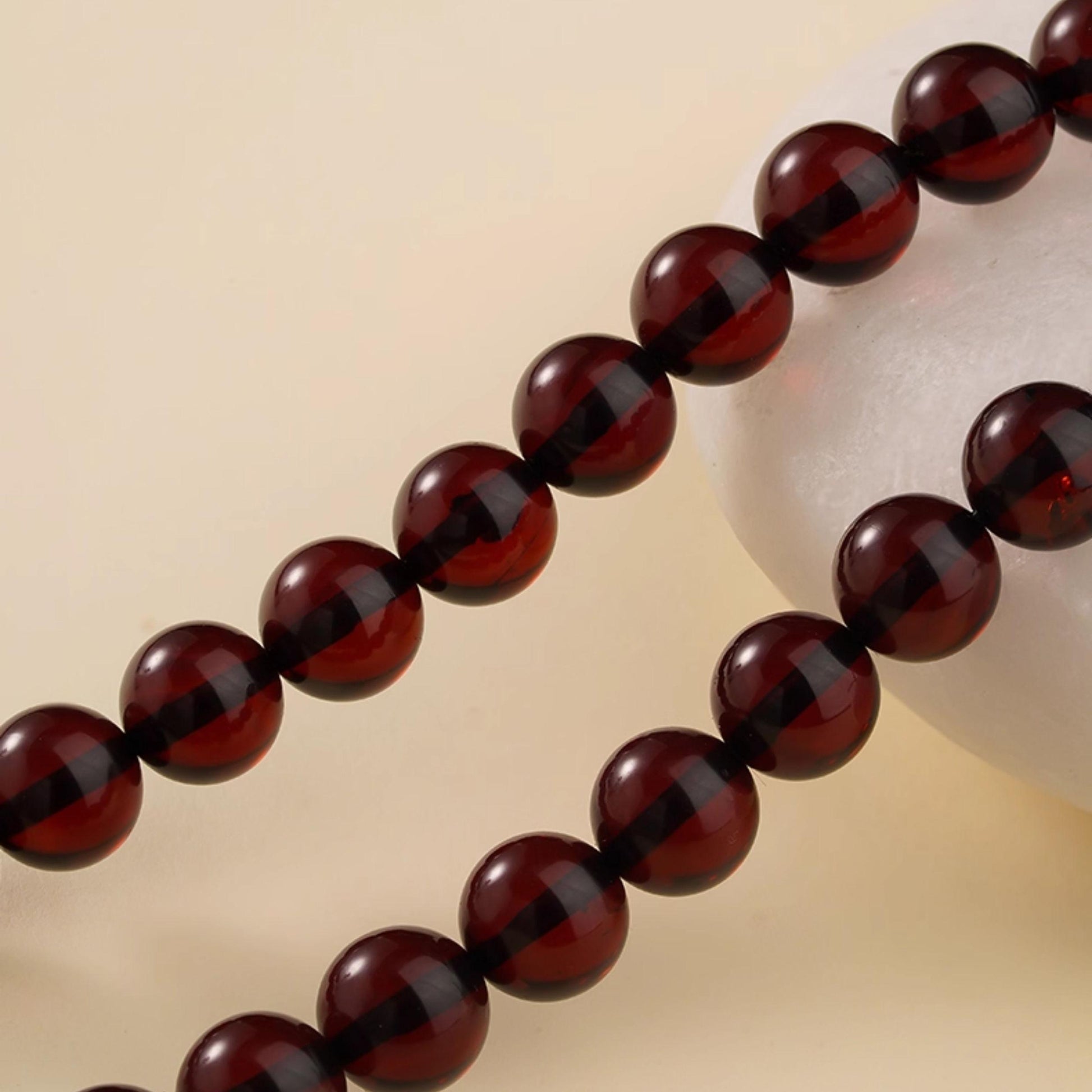 Tibetan art jewelry mala with blood amber beads symbolizing energy, strength, and spiritual growth