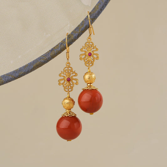 Handcrafted Tibetan Buddhist red agate gold earrings inspired by Tibetan Buddha art and spiritual craftsmanship.