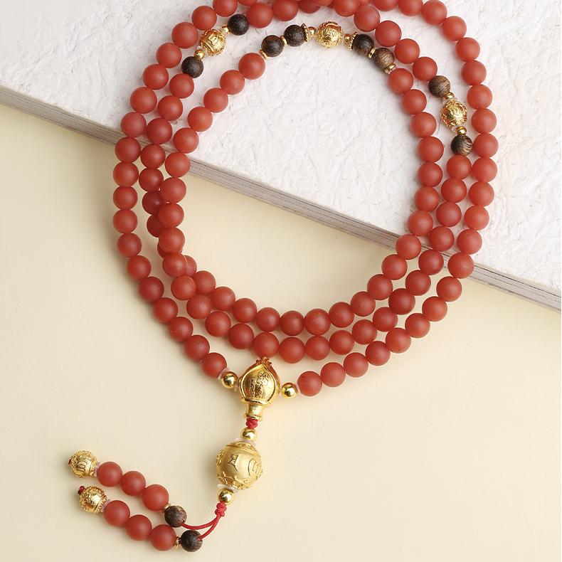 Red agate and agarwood mala with silver six-syllable mantra beads for meditation.