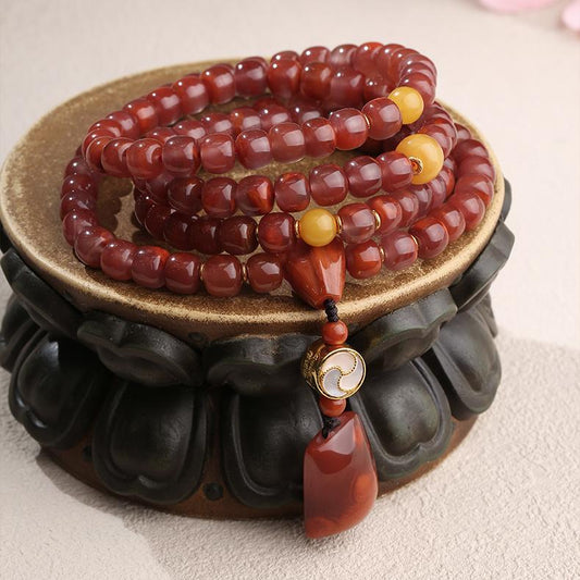 Tibetan Buddhist South Red Agate and amber mala necklace crafted in silver, symbolizing harmony and devotion.