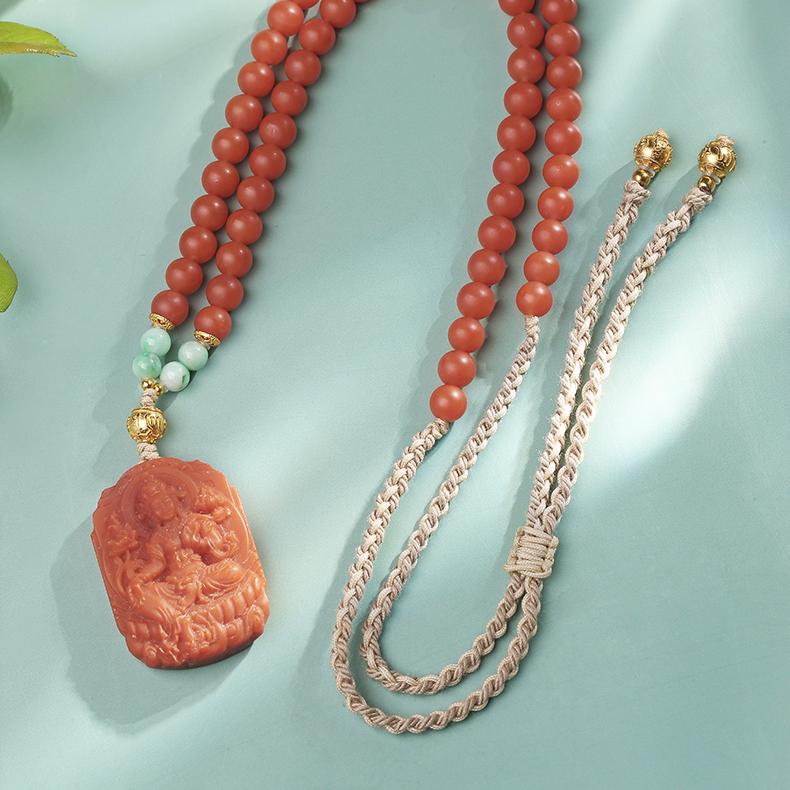 Hand-carved Tara pendant with red agate and jade beads, Tibetan Buddhist jewelry art design.