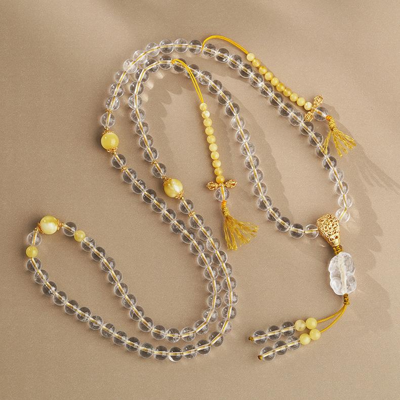 Spiritual white crystal and amber mala necklace featuring silver details for clarity and healing.