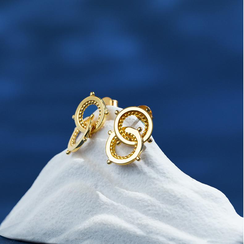 "Tibetan Buddhist-inspired earrings with 925 silver and 18K gold, representing harmony and unity through nature and friendship."