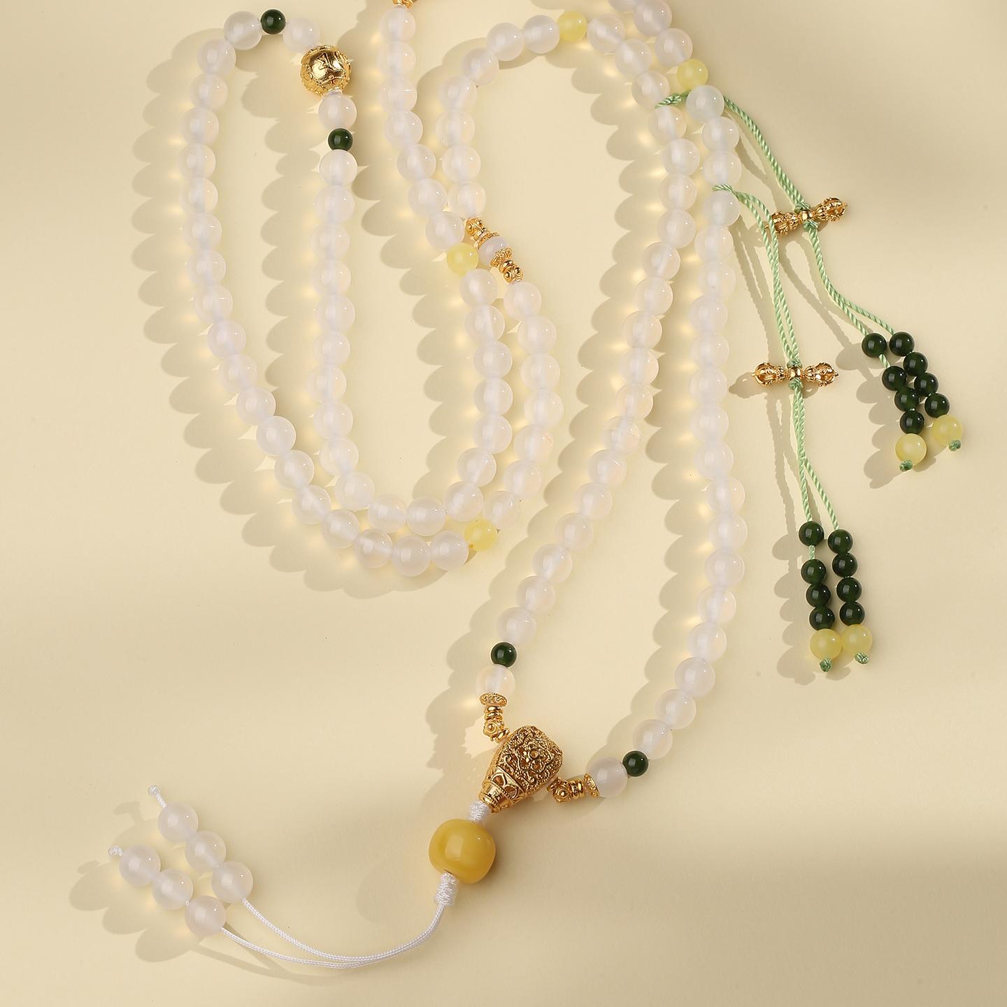 Tibetan-Buddhist mala necklace with amber, agate, jade, and silver elements, representing harmony, focus, and prosperity