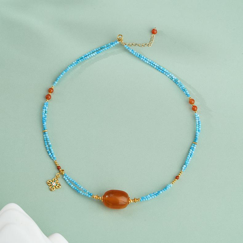 Handmade Tibetan Buddhist amber necklace with turquoise, red coral, and 925 silver pendant for blessings and harmony.