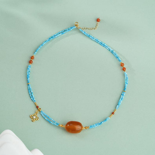 Handmade Tibetan Buddhist amber necklace with turquoise, red coral, and 925 silver pendant for blessings and harmony.