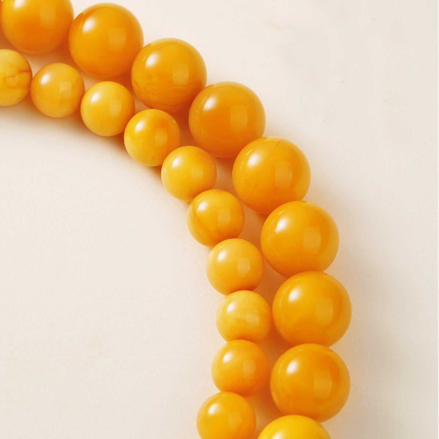 Handcrafted amber necklace featuring jade, pearls, and silver for peaceful energy and spiritual focus.