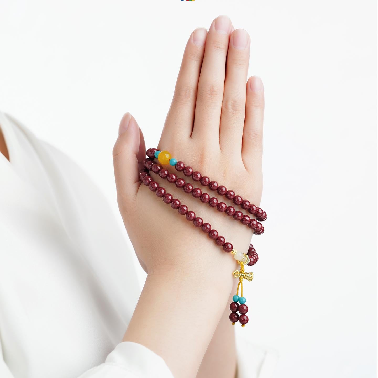 Artisanal cinnabar 108 mala bracelet with agate, jade and glass beads crafted in Tibetan jewelry tradition.