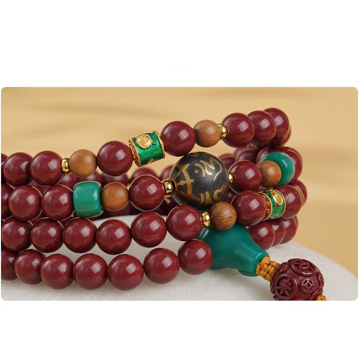 Tibetan-Buddhist mala necklace combining cinnabar, incense ash mantra bead, and copper prosperity beads for meditation