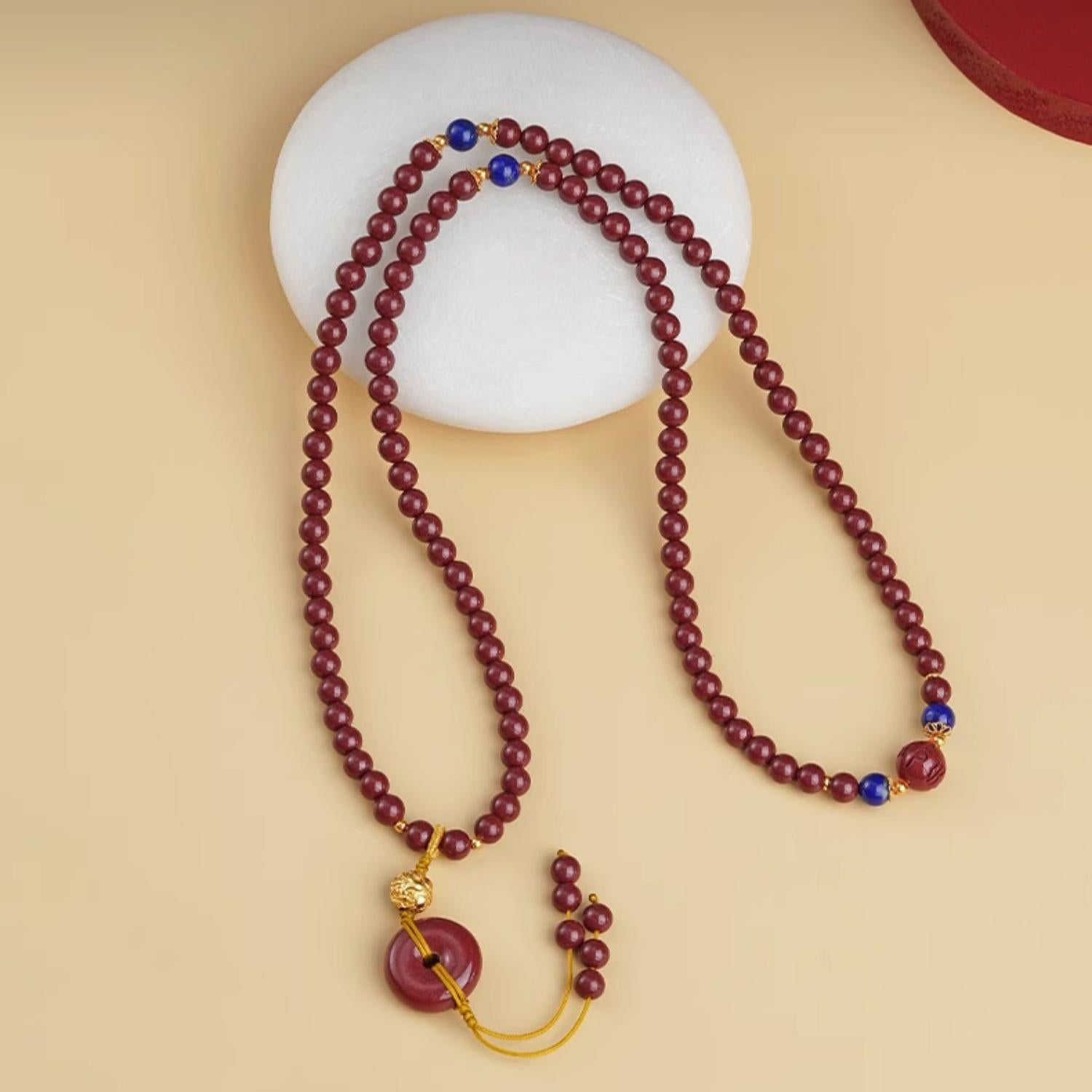 Cinnabar 108 beads mala necklace with lapis lazuli and peace ring pendant