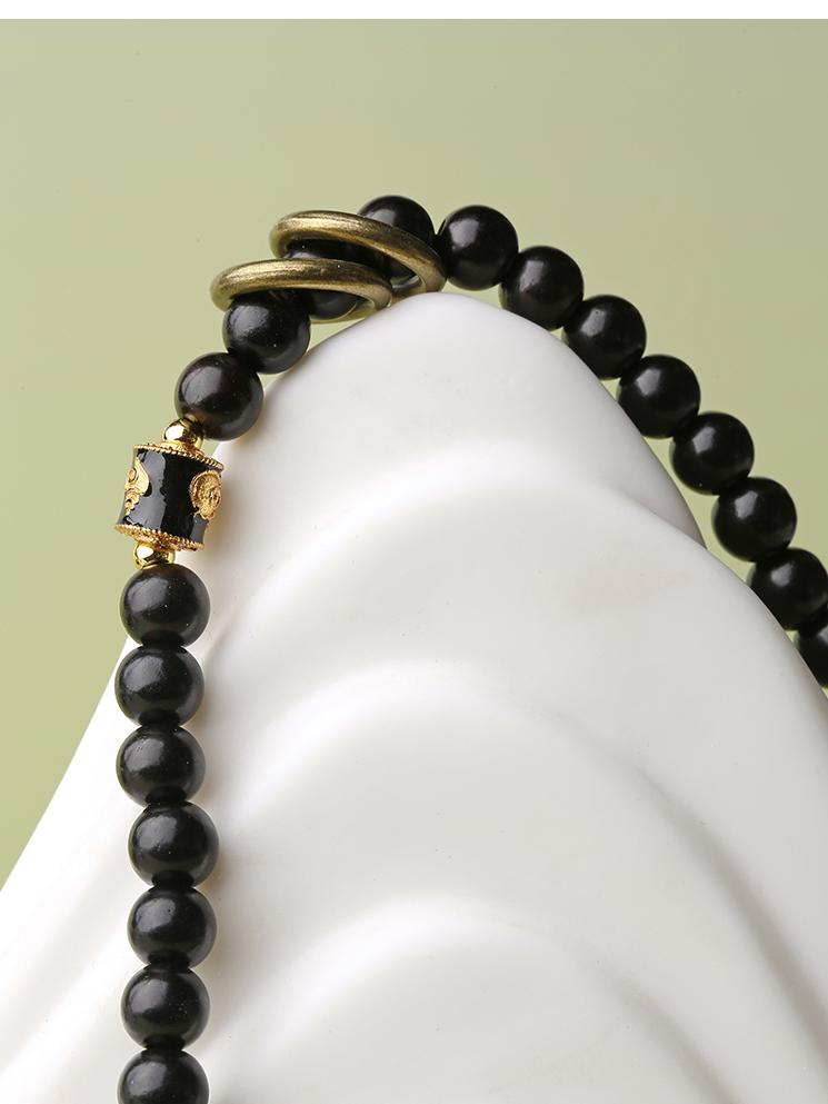 Handmade Tibetan-Buddhist meditation bracelet crafted from ebony, agate, and copper accents