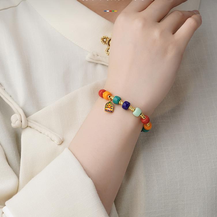 Tibetan-Buddhist handcrafted bracelet featuring glass beads and copper tag pendant