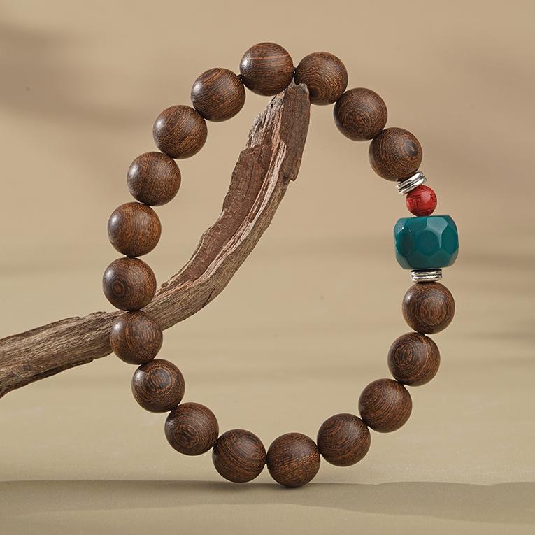 Handmade Tibetan Buddhist bracelet crafted from golden nanmu wood, adorned with intricate thangka painting designs and mantras.