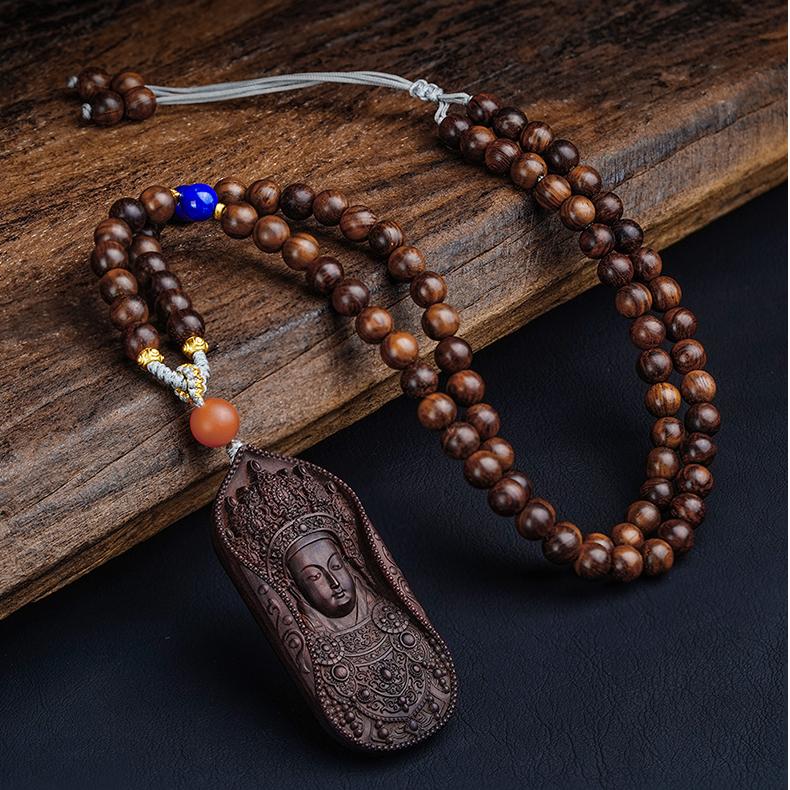 Tibetan Buddhist red sandalwood Guan Yin pendant symbolizing peace and compassion.