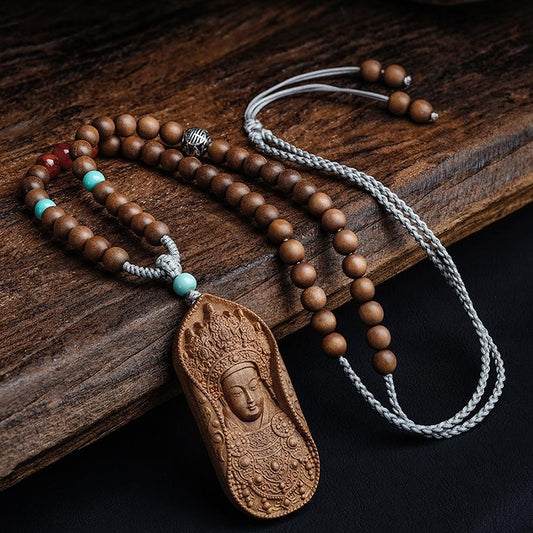 Handcrafted Tibetan Buddhist Avalokiteshvara necklace made of Laosandan wood and silver.