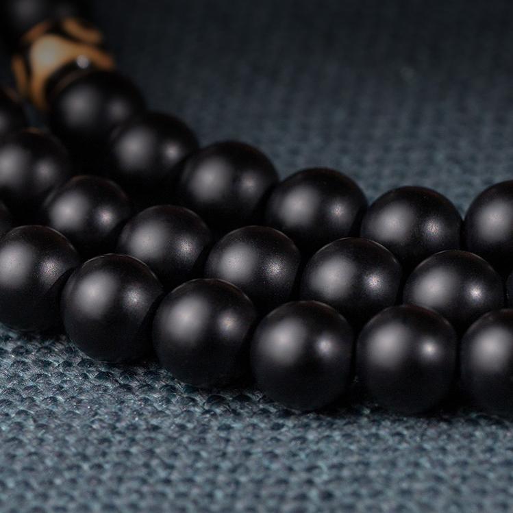 Traditional Tibetan Buddhist obsidian 108 beads mala necklace with elastic cord and carved pendant.