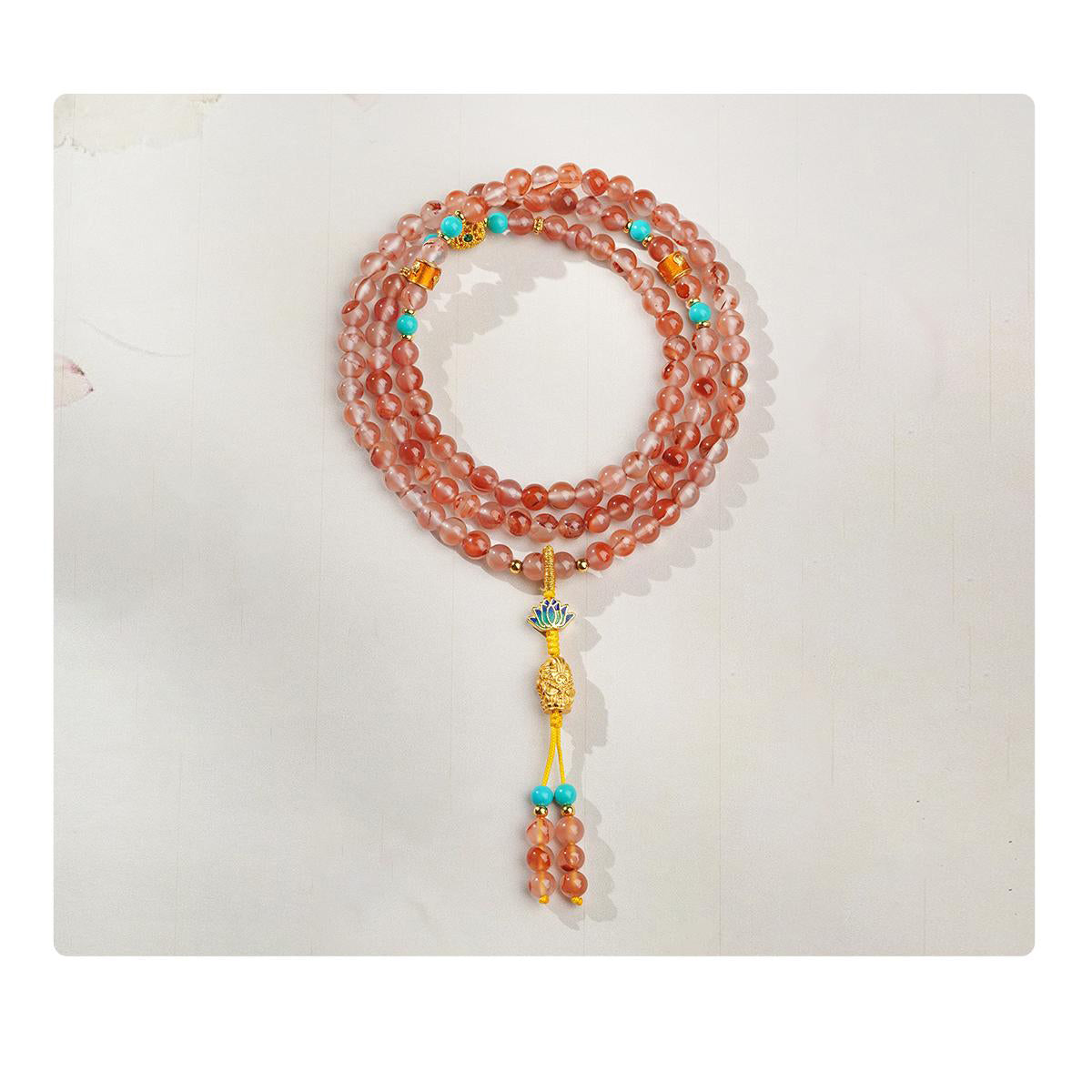 Handcrafted Tibetan Buddhist mala with red agate lotus copper bead and lulu tong copper bead.