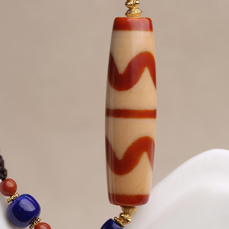 Traditional Tibetan Buddhist pendant featuring red meat agate, double carnelian, and tooth beads, handmade with 925 silver accents.