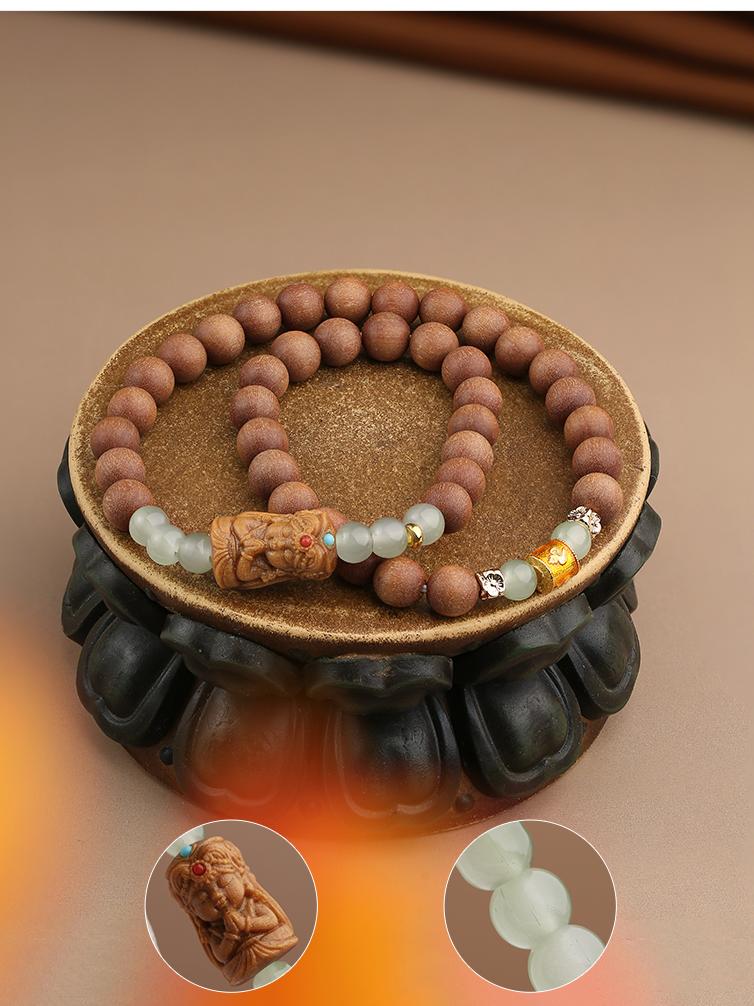 Handcrafted Tibetan-Buddhist Australian sandalwood bracelet featuring carved bead and glass details