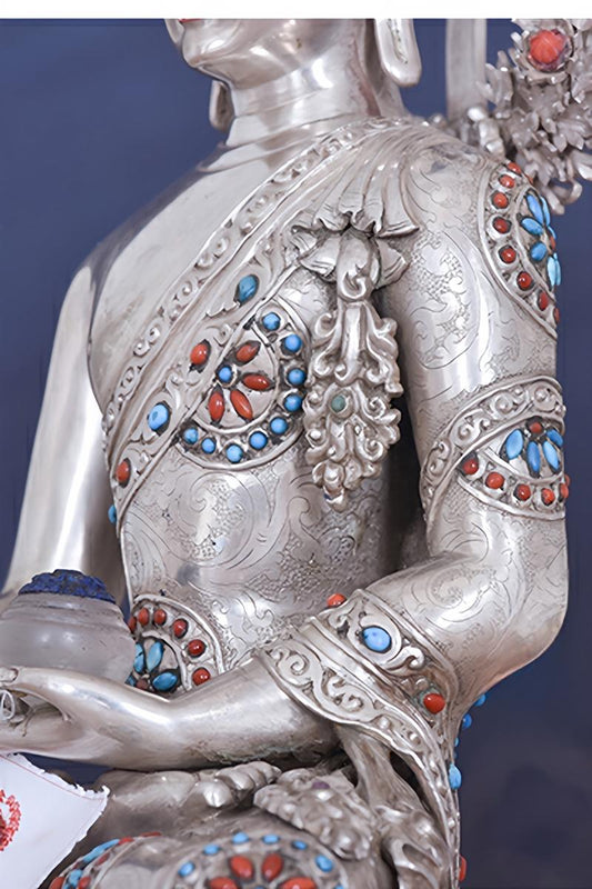 Tibetan-buddhist Shakyamuni Buddha statue, handcrafted in pure silver with mineral pigments, traditional Tibetan Buddha art.
