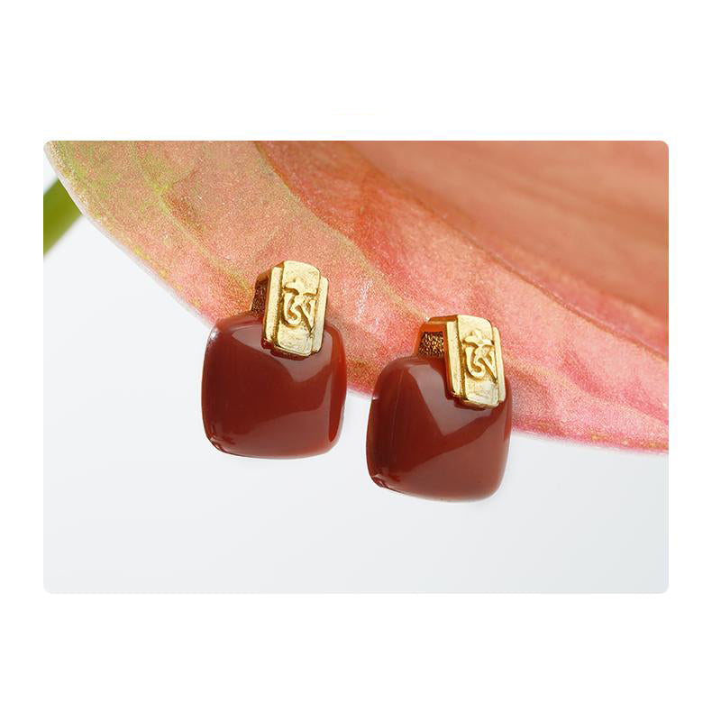 "Handcrafted 925 silver earrings with South Red Coral, symbolizing spiritual growth and connection in Tibetan Buddhist art."