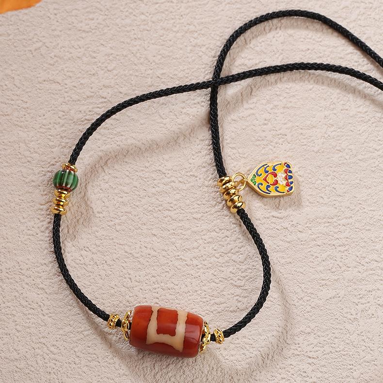 Tibetan Buddhist One-Eye Heaven & Earth Agate and Glass Pendant on an adjustable cord.