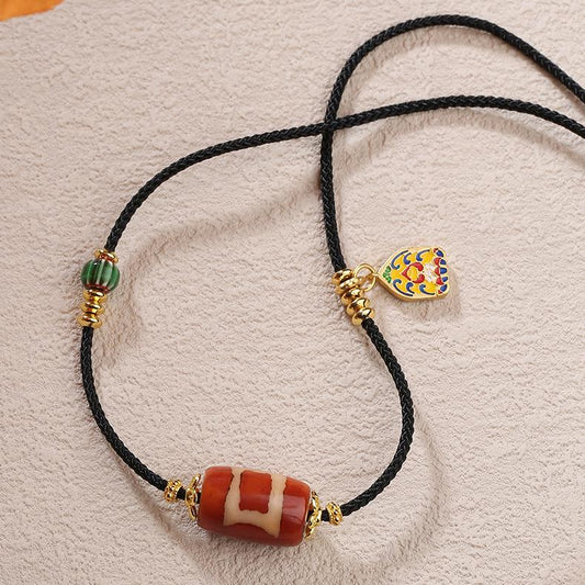 Tibetan Buddhist One-Eye Heaven & Earth Agate and Glass Pendant on an adjustable cord.