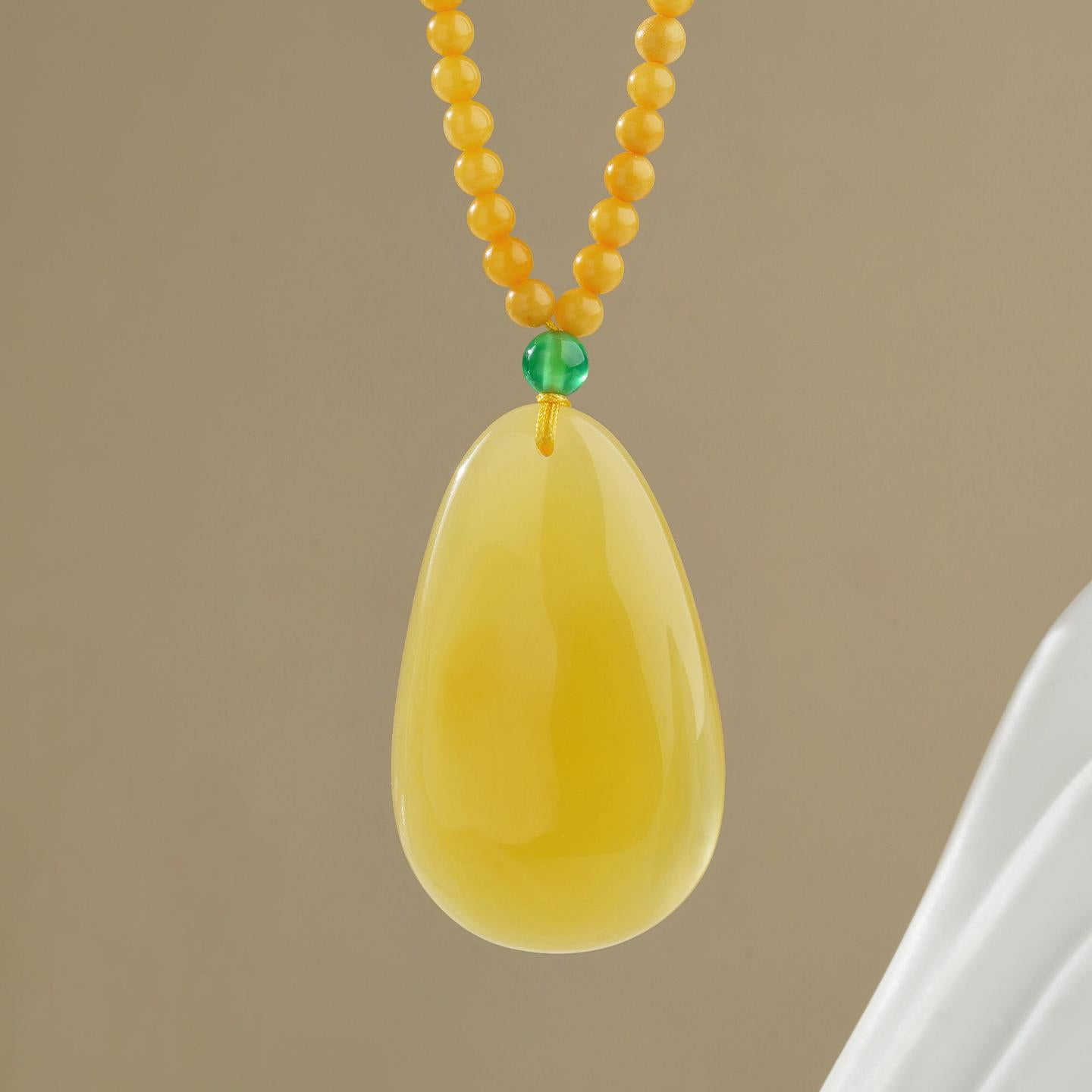 Spiritual amber and silver necklace handcrafted to enhance peace, prosperity, and mindfulness.