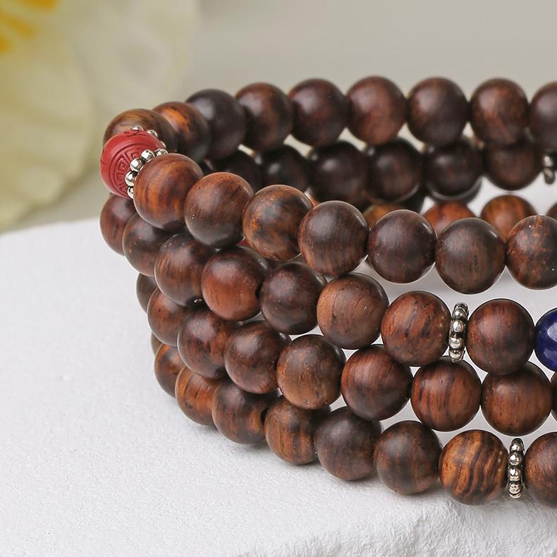 Tibetan-Buddhist mala necklace featuring cinnabar Pixiu charm and Huanghuali wood beads symbolizing protection and fortune