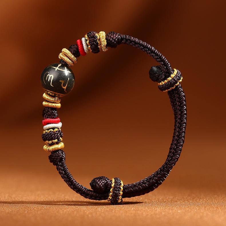 Brown adjustable Tibetan Buddhist bracelet featuring a 13mm incense-ash Om Mani Padme Hum bead, artisan crafted.