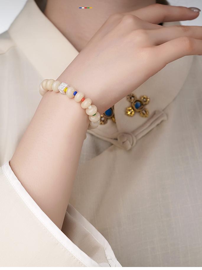 A person gently holding the hand-strung QIanlan Bodhi seed bracelet. This image conveys the serene and calming nature of this jewelry art piece, illustrating its role as a personal accessory for peace and spiritual connection.