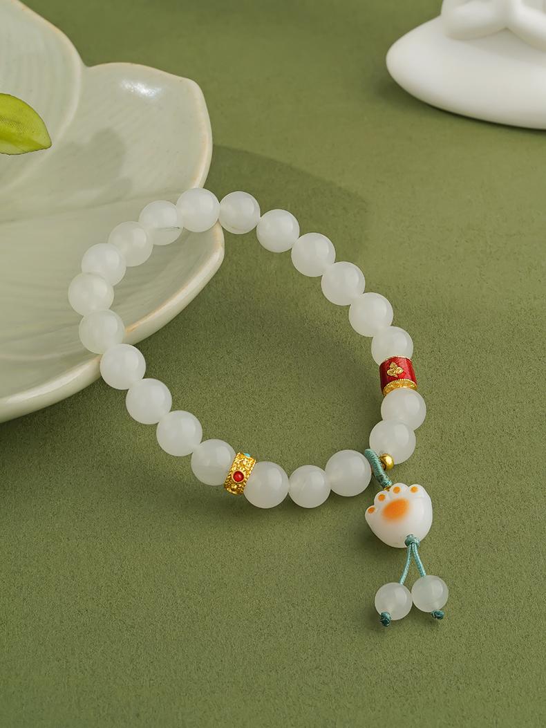 Artisanal handcrafted Golden Silk Jade gourd bracelet carrying blessings of health and prosperity. Each gourd is carefully shaped and polished, embodying the essence of blessing jewelry art.