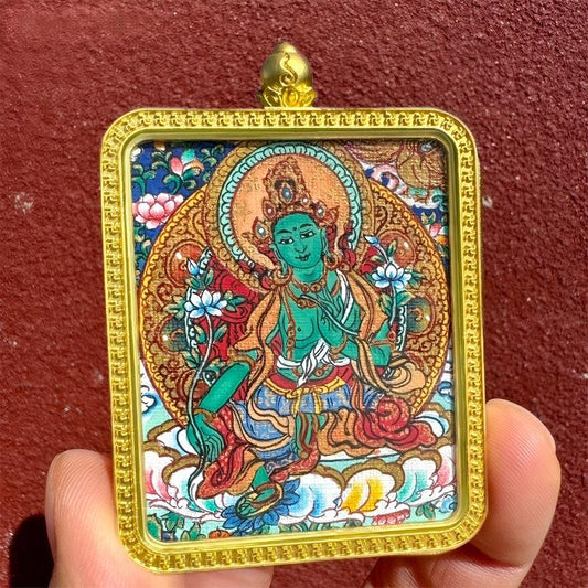 Hand-painted Tibetan Buddhist pendant featuring Yellow Jambhala, Green Tara, Amitabha, and Acala in a Thangka design, crafted as jewelry art with spiritual blessings.