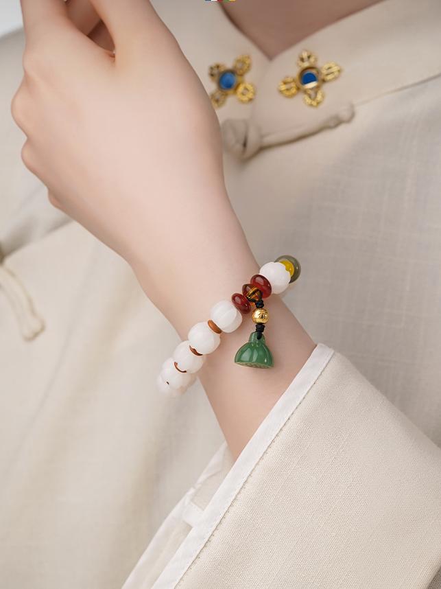 Lifestyle image of the elegant QIanlan Bodhi bracelet being worn in a casual, everyday setting. This picture demonstrates how this modern jewelry art piece with traditional roots can integrate spirituality into modern life.