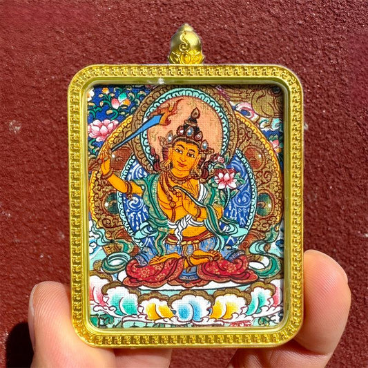 Handcrafted Tibetan pendant with Yellow Jambhala, Green Tara, and Amitabha in a Thangka design, blending spiritual symbolism with exquisite Tibetan jewelry art.