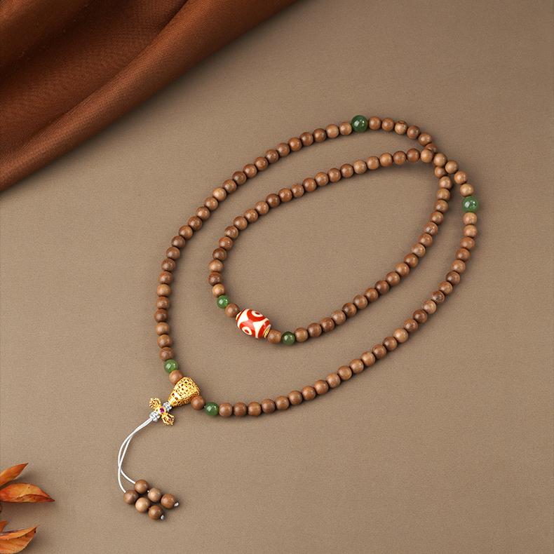 Tibetan-Buddhist mala necklace made with jade, Laosandal wood, and agate Dzi bead symbolizing peace and protection