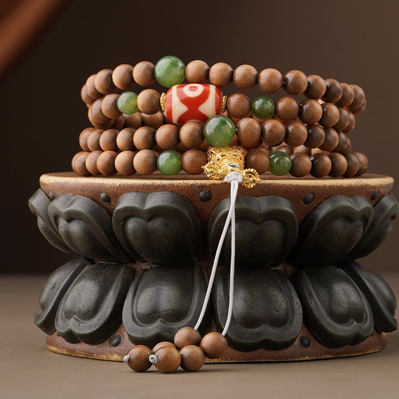 Handmade Tibetan mala necklace crafted from Laosandal wood, green jade, agate Dzi bead, and 925 silver Vajra elements