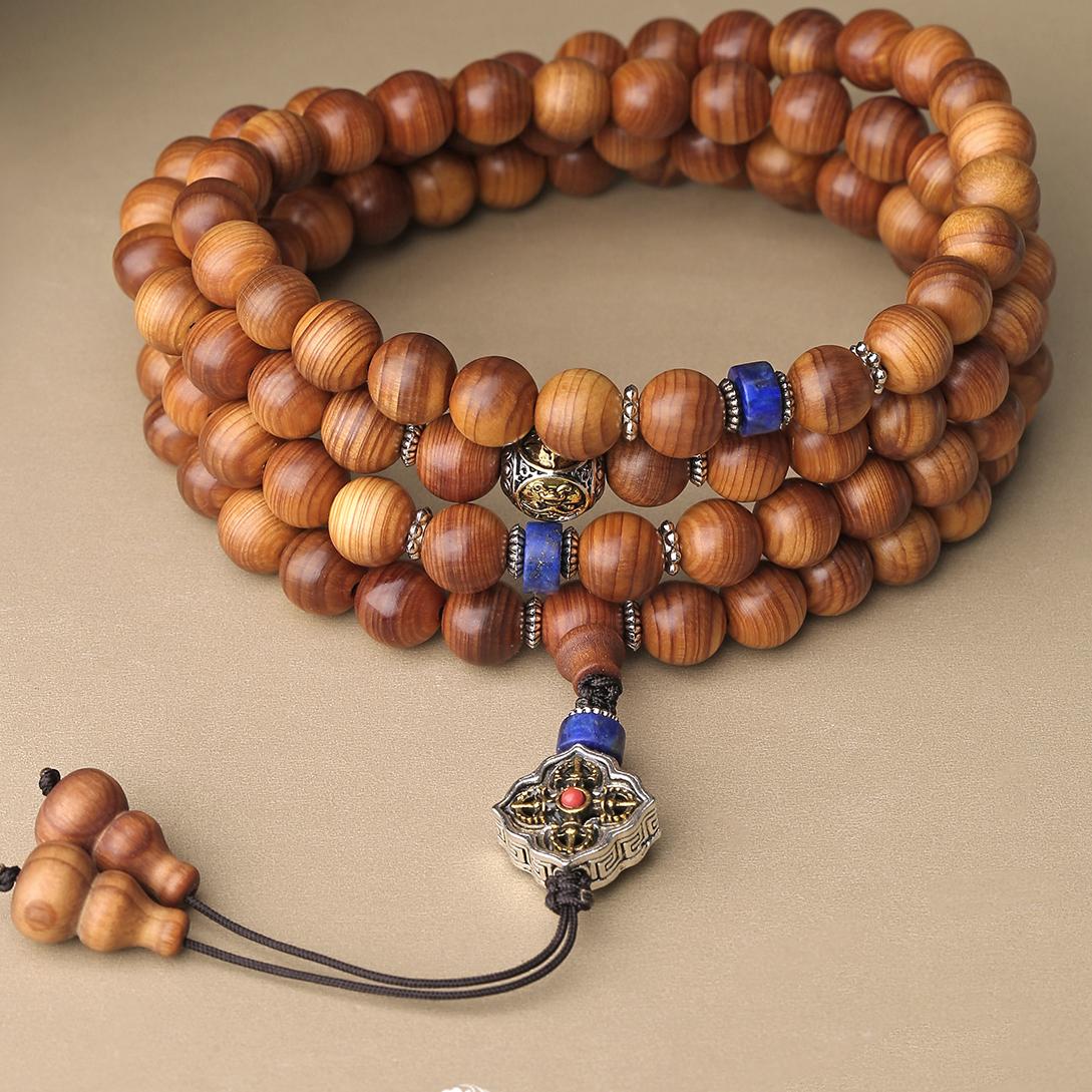 Tibetan Buddhist mala with cypress three-way guru bead symbolizing guidance and spiritual connection.