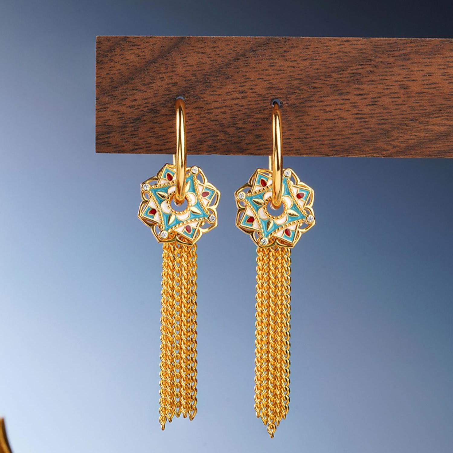 "Handmade Tibetan Buddhist Lian Kai Fan Hua earrings in 925 silver with hollow lotus design and silver tassels, symbolizing purity and spiritual growth."