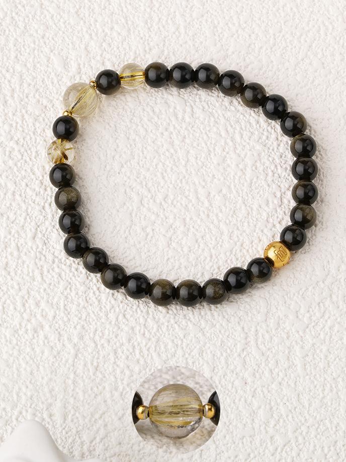 Alt text: Tibetan Buddhist Liuying Golden Obsidian Bracelet handcrafted with rutilated quartz and silver beads