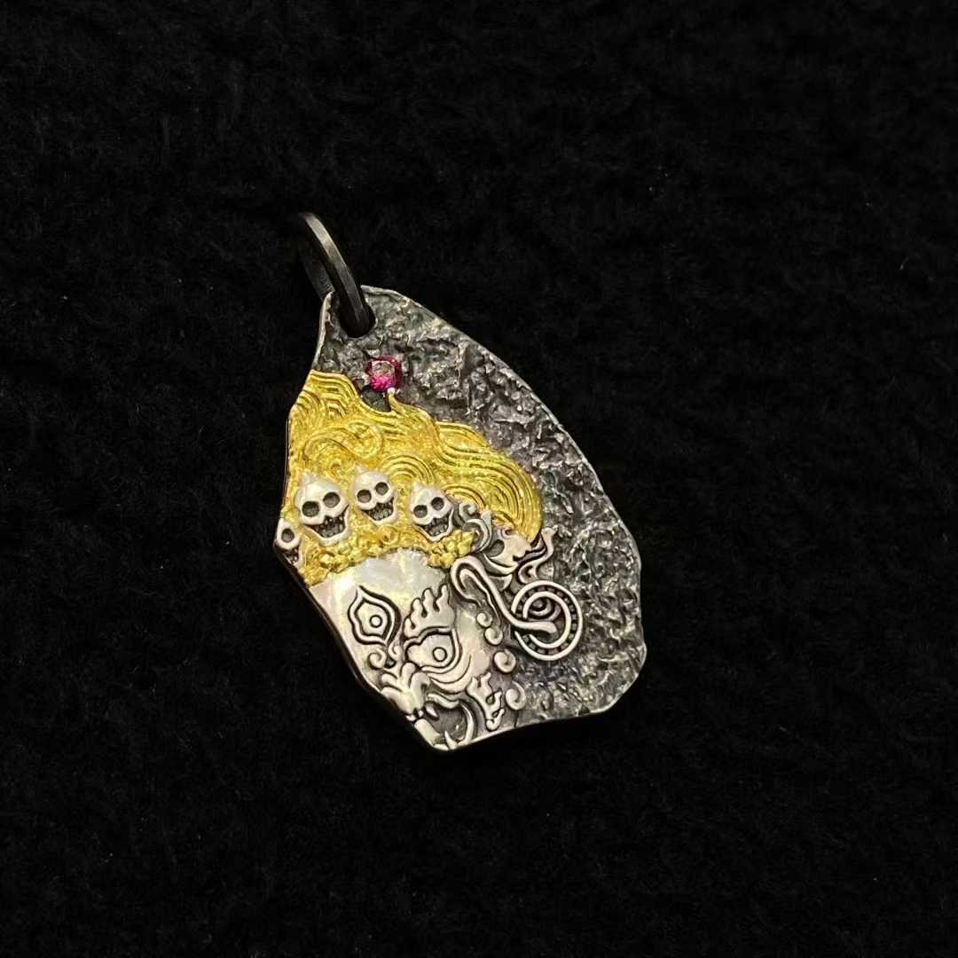 Artisan-made Mahakala pendant in pure gold and silver with precision handcrafted inlay.