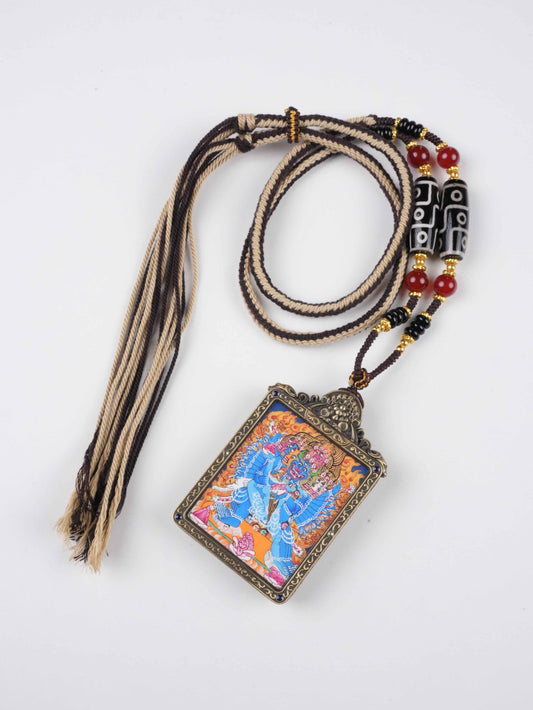 Miniature Tibetan Thangka pendant featuring Mahasamvara, crafted on canvas with natural mineral pigments.