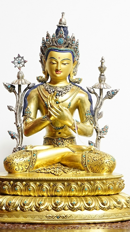 Handcrafted Tibetan Buddhist Maitreya Buddha statue made of pure silver with gilded details and mineral pigments, symbolizing joy, compassion, and future enlightenment.