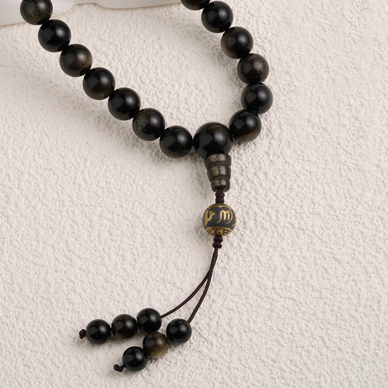 Tibetan handcrafted mala with golden obsidian and a three-way connector bead.