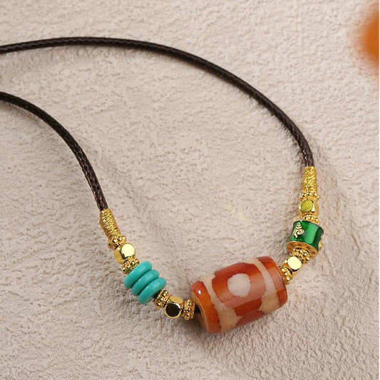 Tibetan Buddhist Three Eyes Dzi Pendant carved from moss agate with a detailed copper alloy setting.