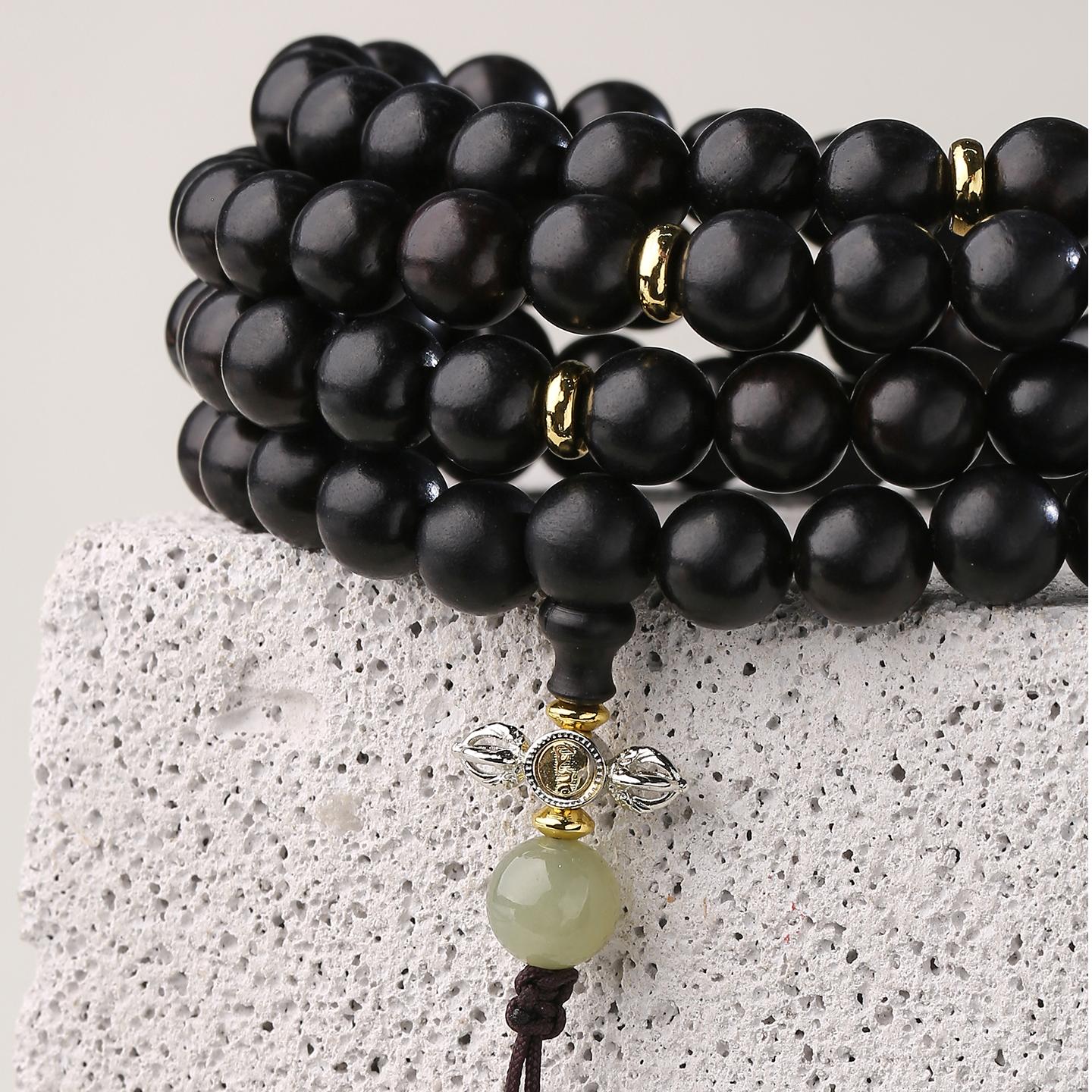 Detailed close-up of handcrafted Tibetan Buddhist ebony 108 mala beads