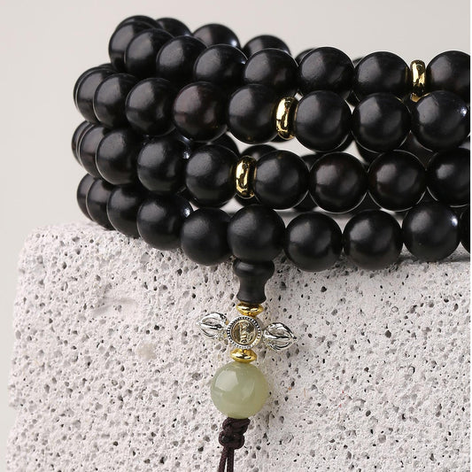 Detailed close-up of handcrafted Tibetan Buddhist ebony 108 mala beads
