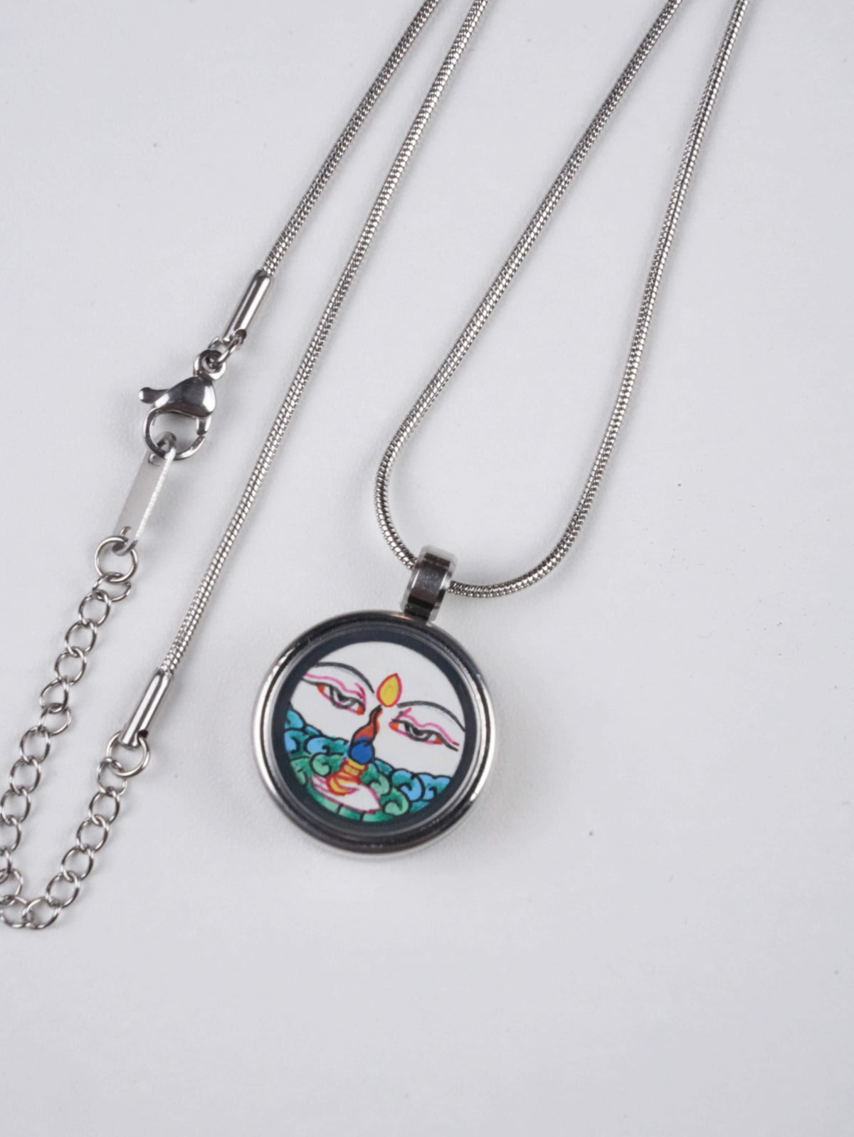 Tibetan Buddhist White Tara thangka jewelry pendant, sacred handmade art representing compassion and longevity, traditional Tibetan Buddha art.